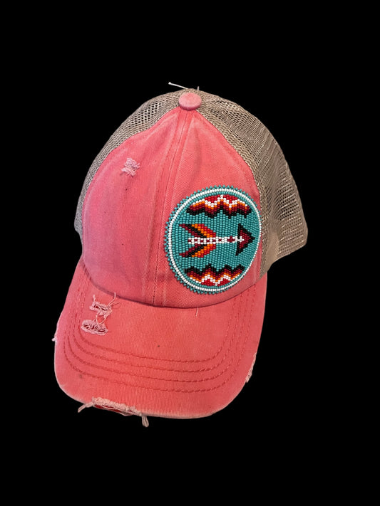 Coral criss-cross ponytail hat with beaded patch